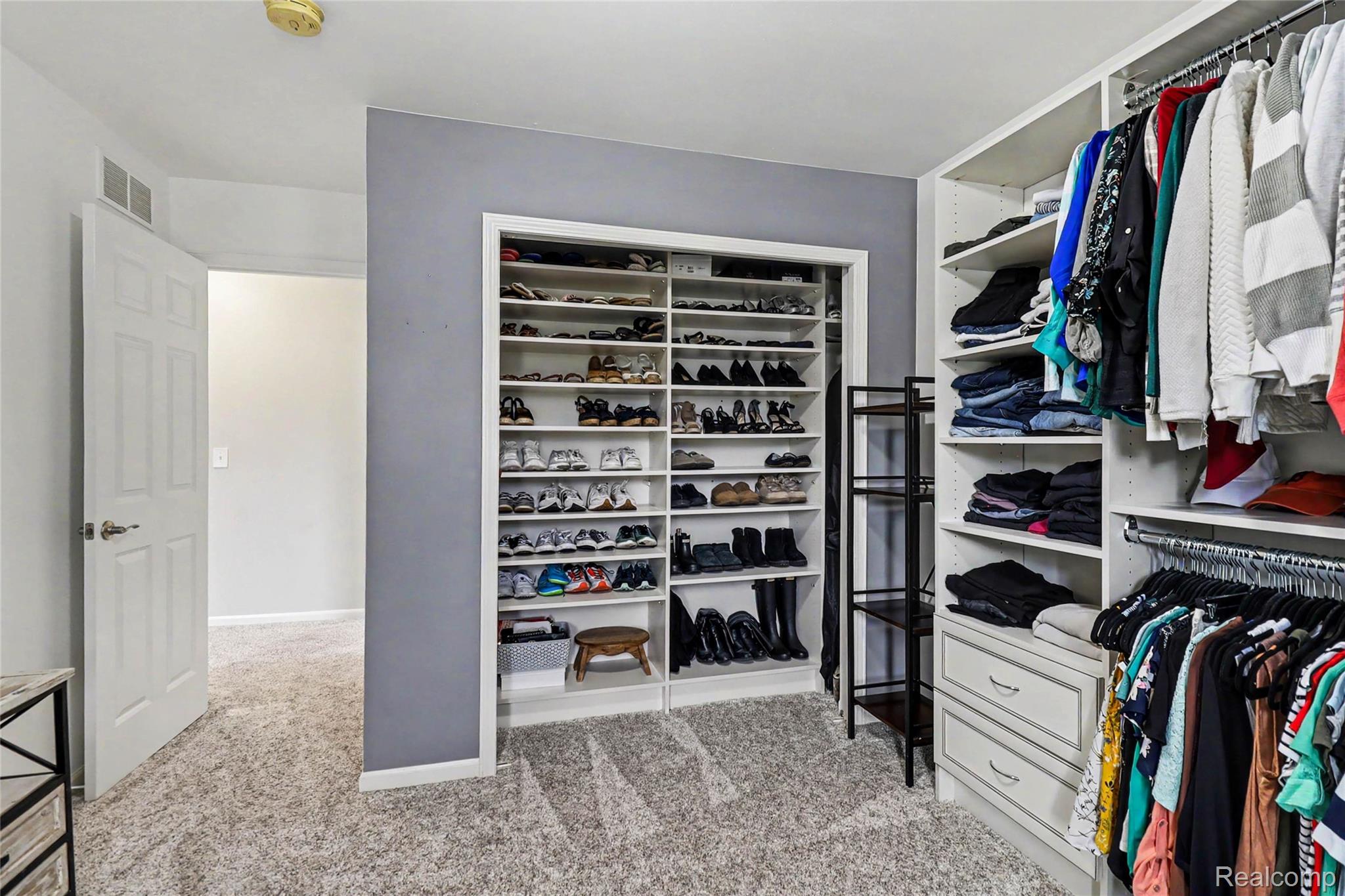 2548 Empire Court Rochester, MI 48309 - Photo 30 of 40 Custom closet system featuring extensive shelving, hanging rods, and built-in drawers