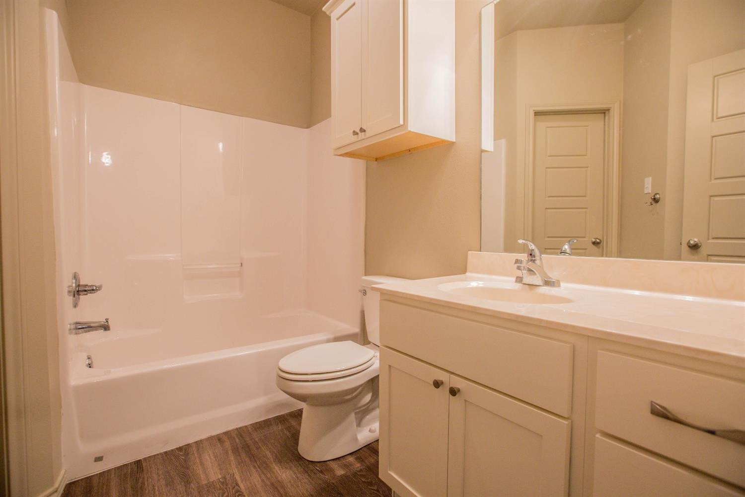 2123 10th Street Lubbock, TX 79401 - Photo 11 of 14 a bathroom with a sink toilet and shower