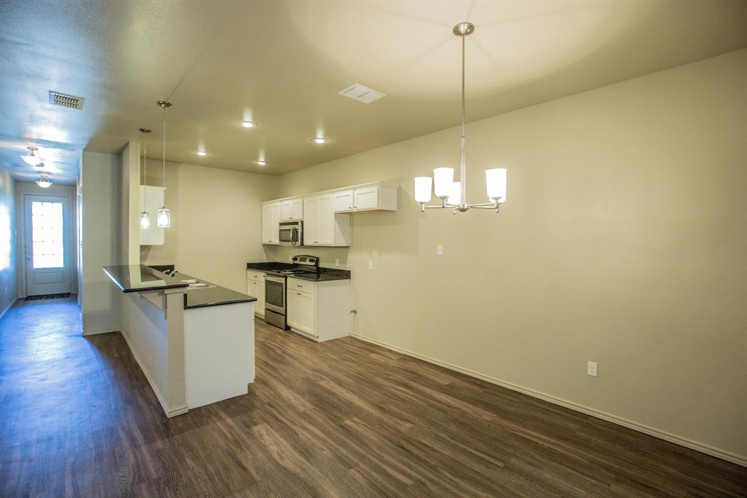 2123 10th Street Lubbock, TX 79401 - Photo 5 of 14 a view of kitchen with sink and wooden floor
