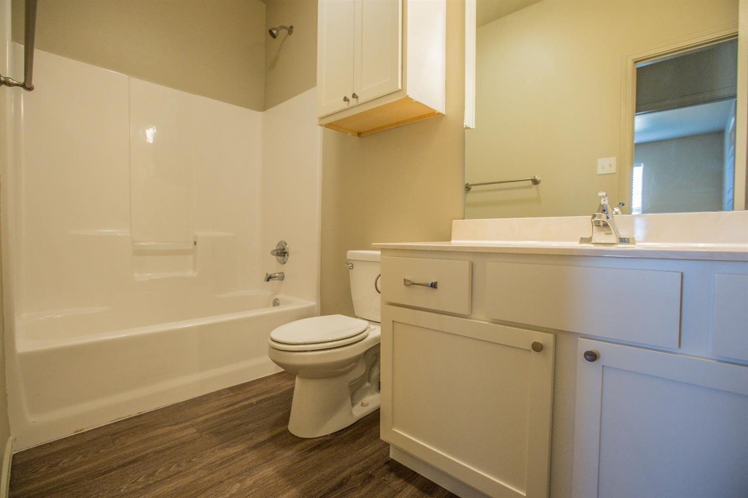 2123 10th Street Lubbock, TX 79401 - Photo 8 of 14 a bathroom with a sink and a mirror