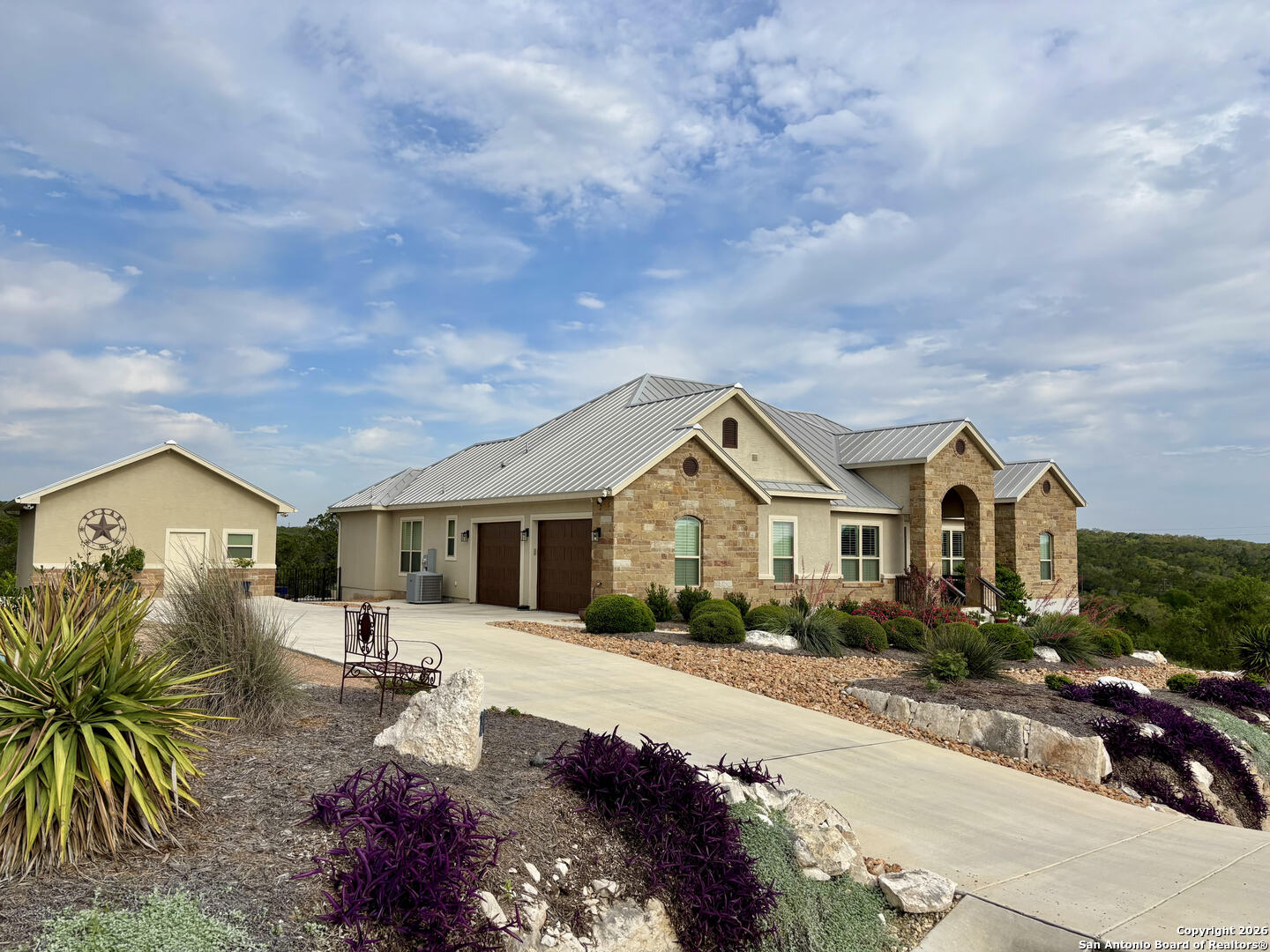 a front view of a house with a garden