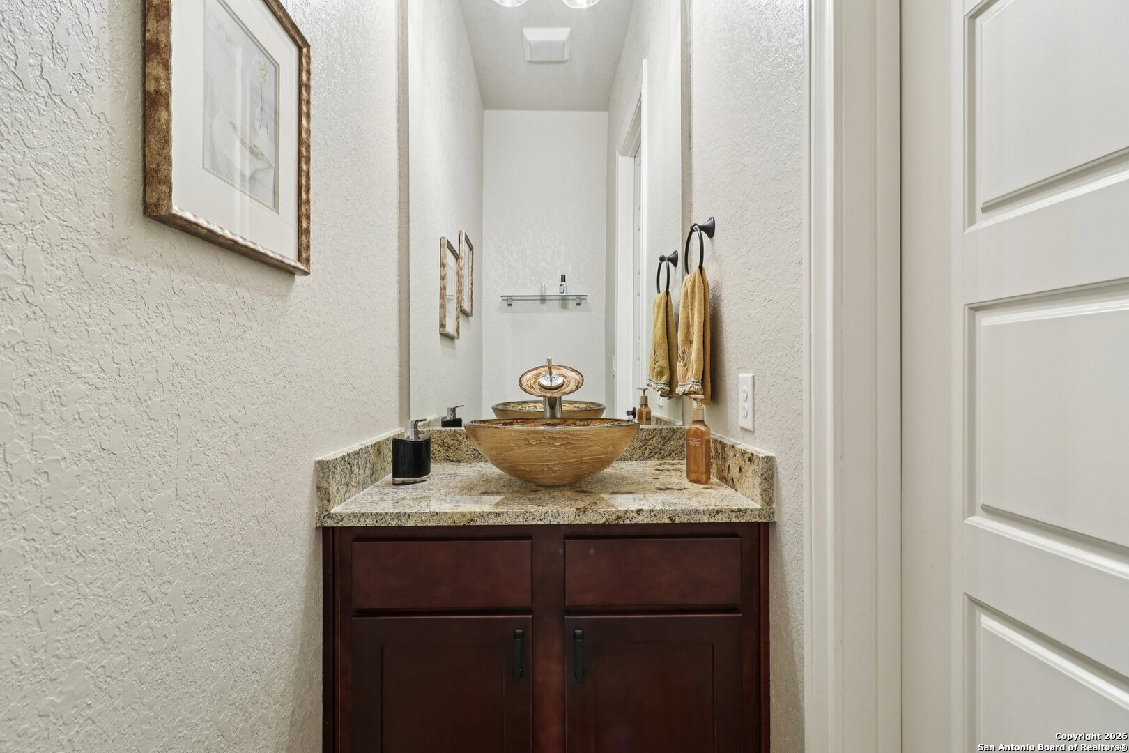 156 Pr 2771 Mico, TX 78056 - Photo 34 of 50 a bathroom with a granite countertop sink and a mirror