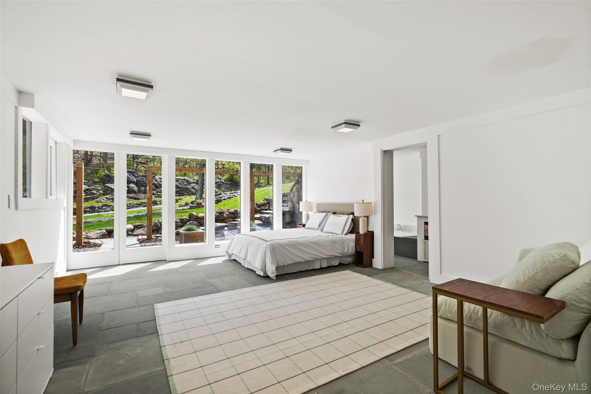 496 Haines Road Bedford Corners, NY 10549 - Photo 23 of 35 a spacious bedroom with a large bed and a large window