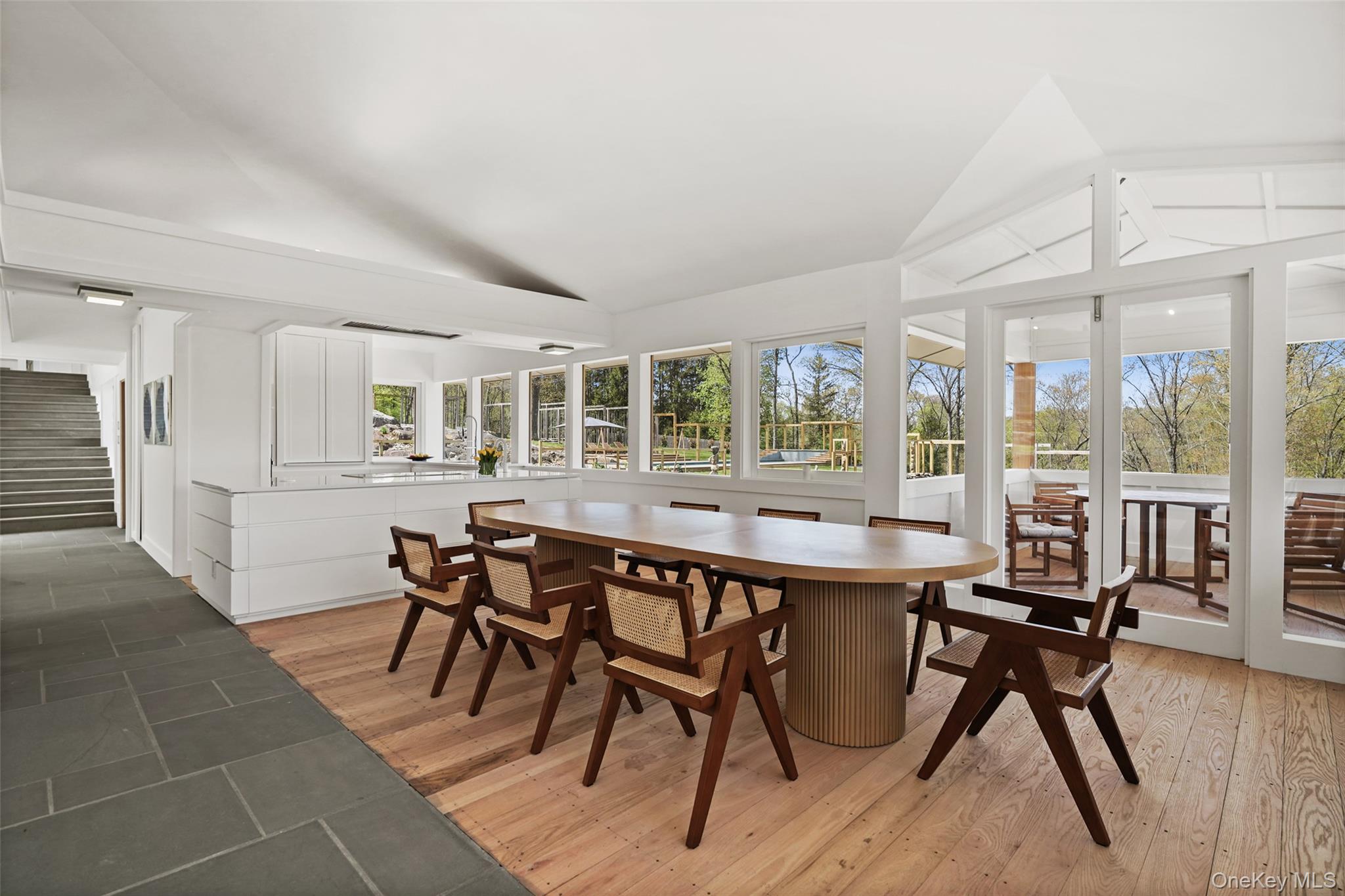 496 Haines Road Bedford Corners, NY 10549 - Photo 9 of 35 a dining room with a wooden table and chairs