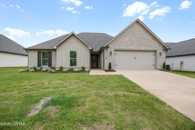 a front view of house with yard and green space