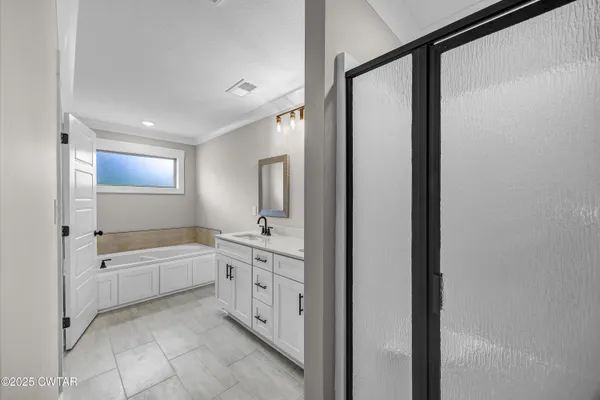 an empty room with windows and ceiling fan