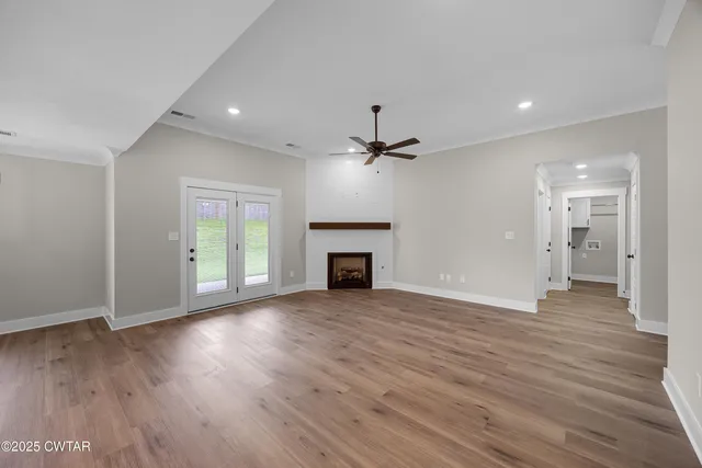 a view of empty room with a fireplace and fan