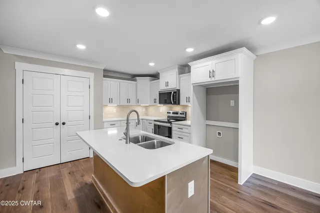 a view of kitchen with sink microwave and refrigerator