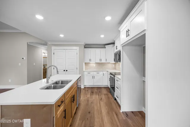 a kitchen with kitchen island a sink stove and refrigerator