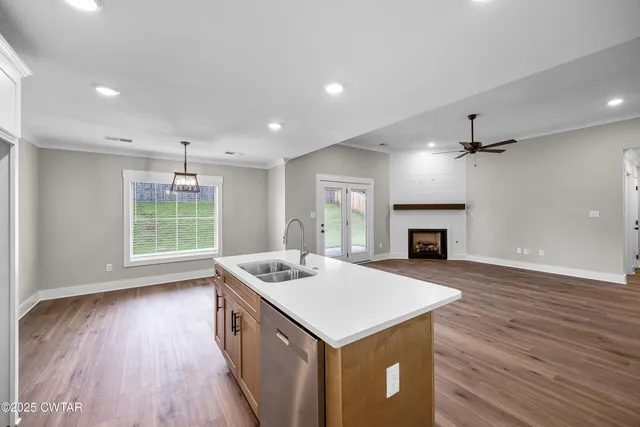 a kitchen with kitchen island a sink stove and refrigerator