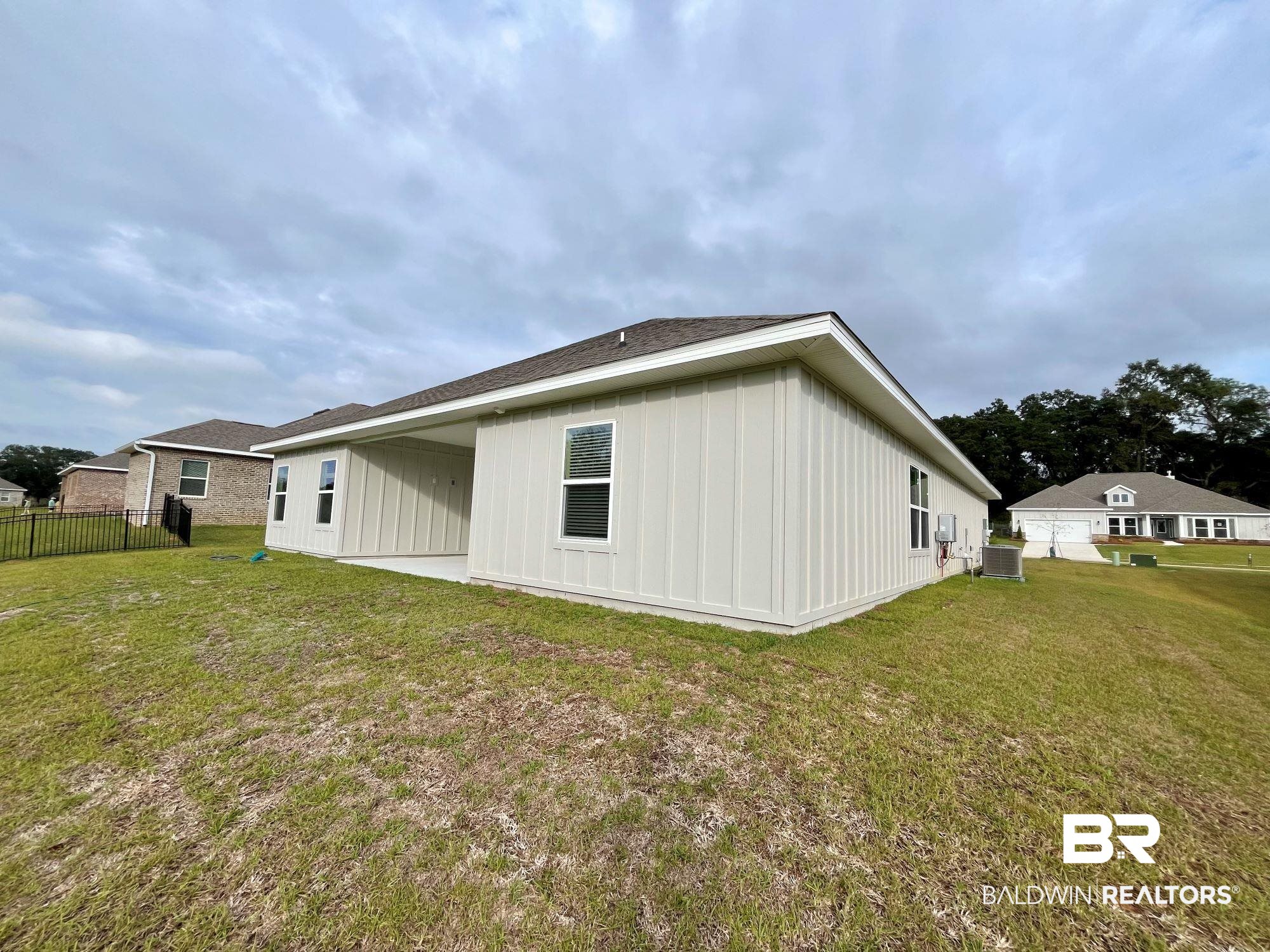 337 Barndling Street Fairhope, AL 36532 - Photo 31 of 34 Back of property with cooling unit, a yard, and a patio area