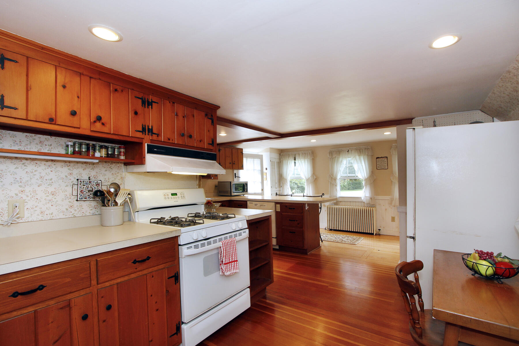 958 Long Pond Road Brewster, MA 02631 - Photo 14 of 38 a kitchen with stainless steel appliances granite countertop a stove a sink dishwasher and a refrigerator with wooden cabinets
