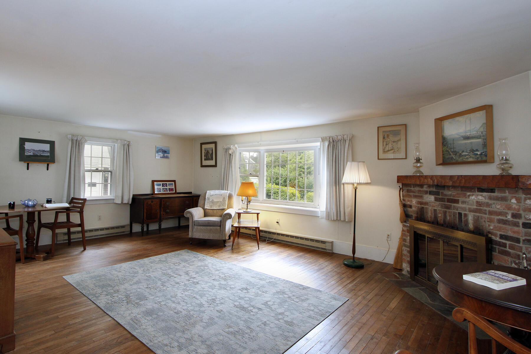 958 Long Pond Road Brewster, MA 02631 - Photo 18 of 38 a living room with furniture and a fireplace