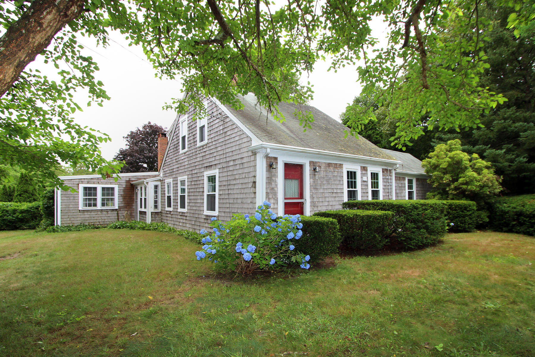 958 Long Pond Road Brewster, MA 02631 - Photo 3 of 38 a front view of a house with a garden