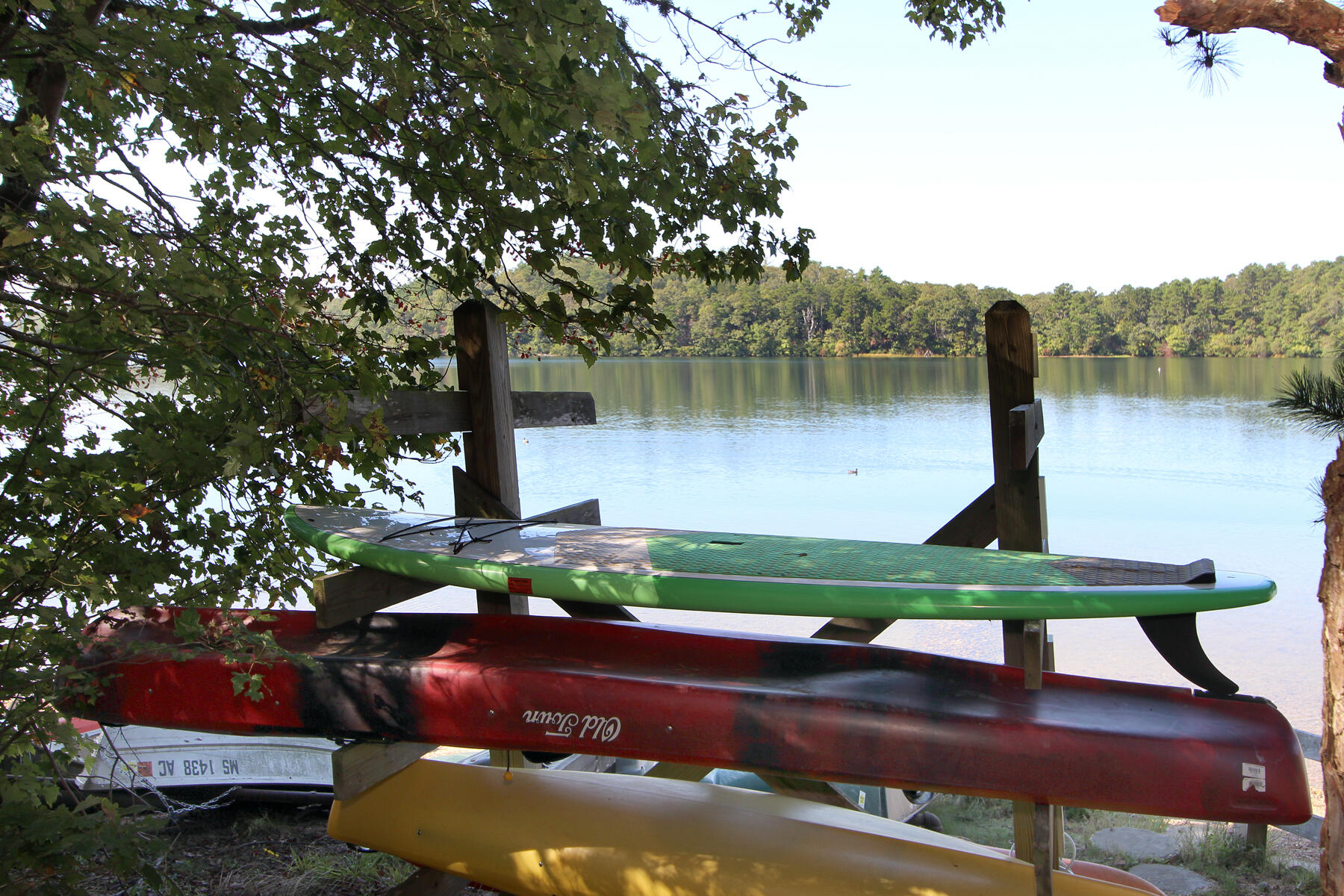 958 Long Pond Road Brewster, MA 02631 - Photo 36 of 38 a wooden bench sitting next to a lake