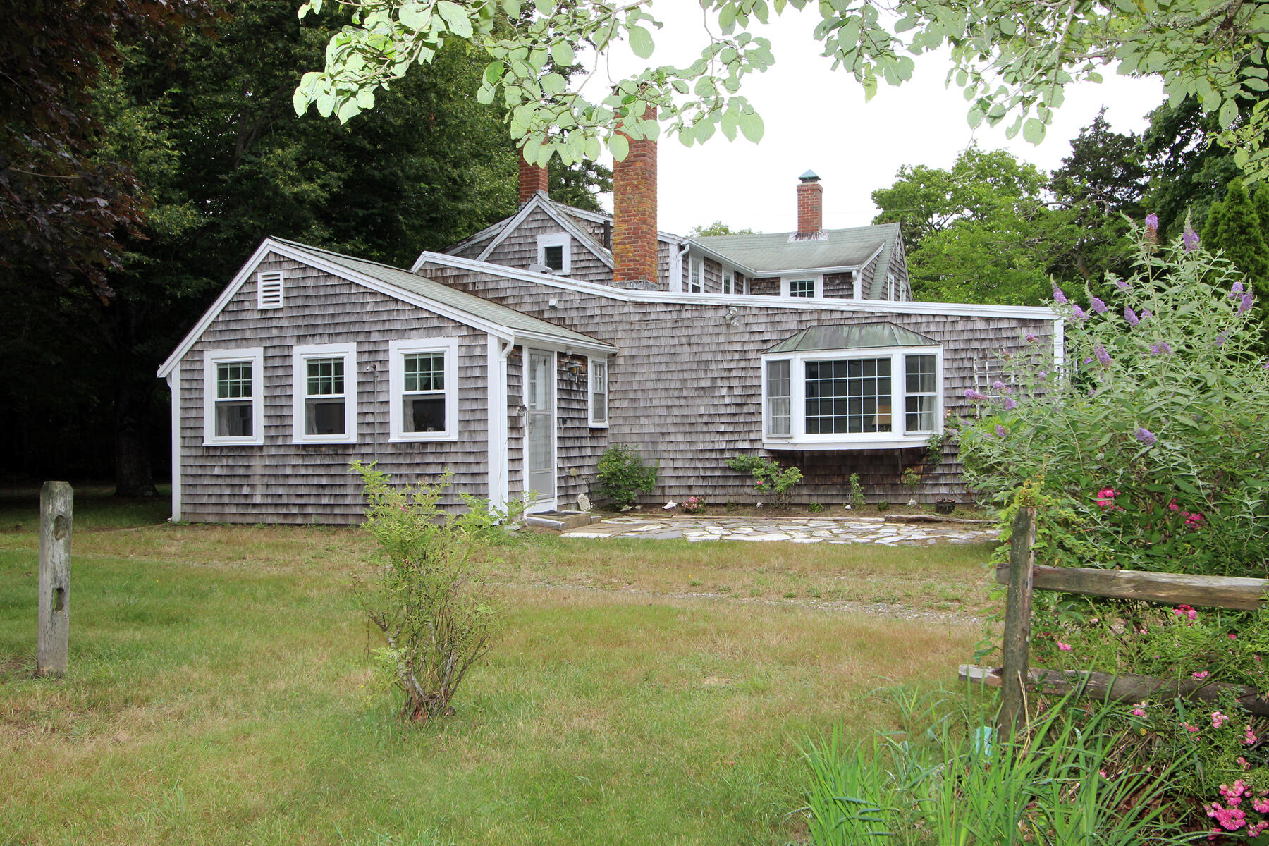 958 Long Pond Road Brewster, MA 02631 - Photo 4 of 38 a front view of a house with a yard