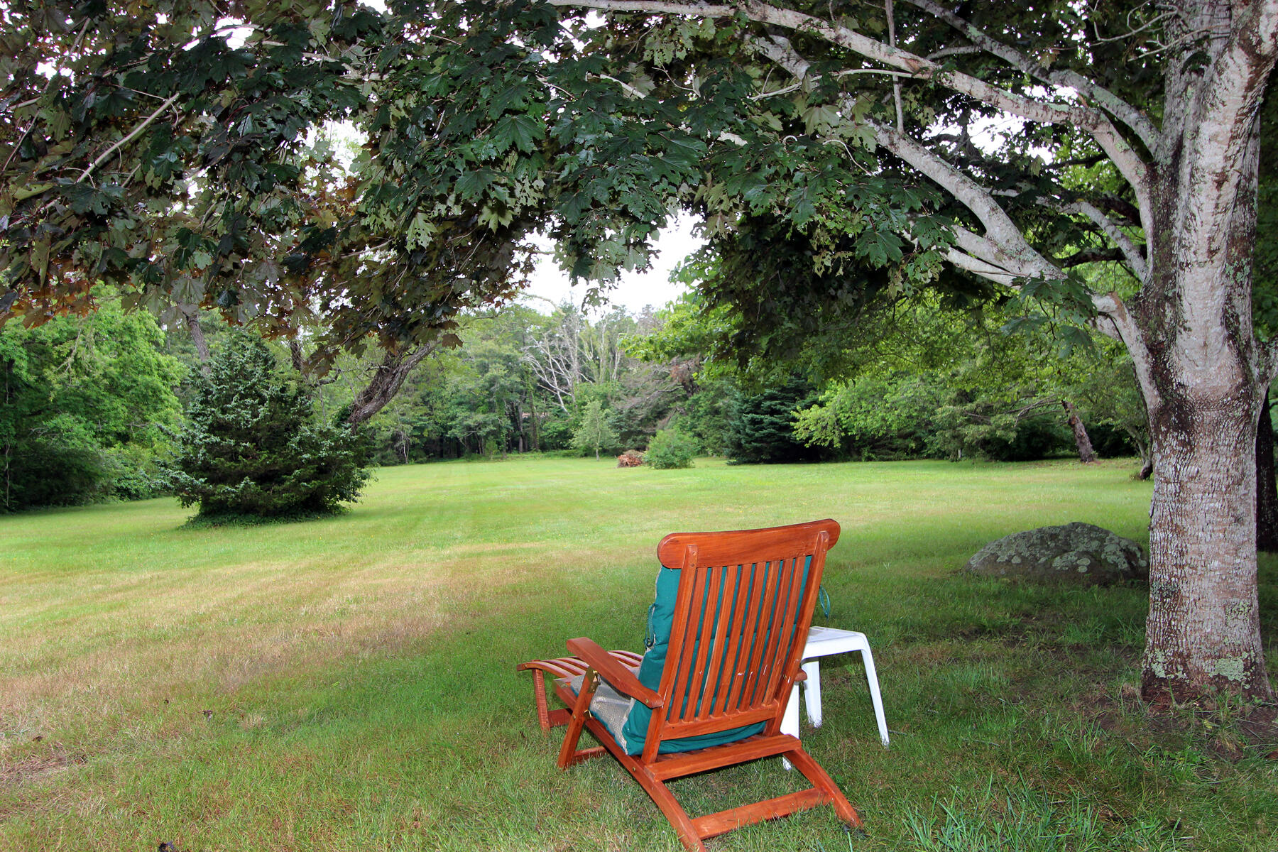 958 Long Pond Road Brewster, MA 02631 - Photo 7 of 38 a backyard of a house with table and chairs