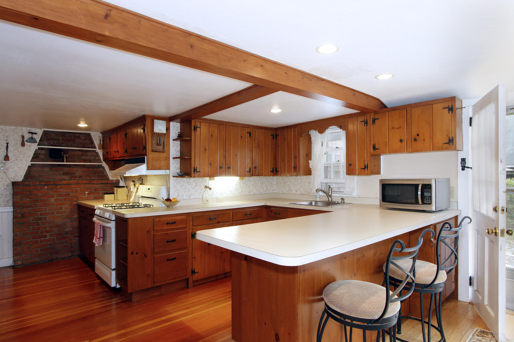 958 Long Pond Road Brewster, MA 02631 - Photo 10 of 38 a kitchen with stainless steel appliances a stove a sink dishwasher and a refrigerator with wooden floor
