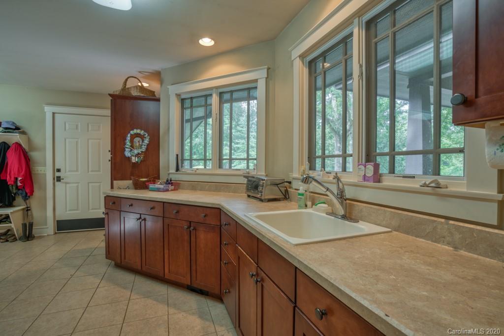 305 Misty Hill Road Columbus, NC 28722 - Photo 13 of 46 a spacious bathroom with a granite countertop sink and a large mirror