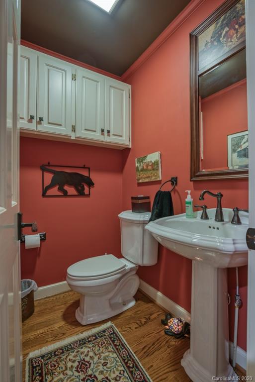 305 Misty Hill Road Columbus, NC 28722 - Photo 21 of 46 a bathroom with a granite countertop toilet and a sink