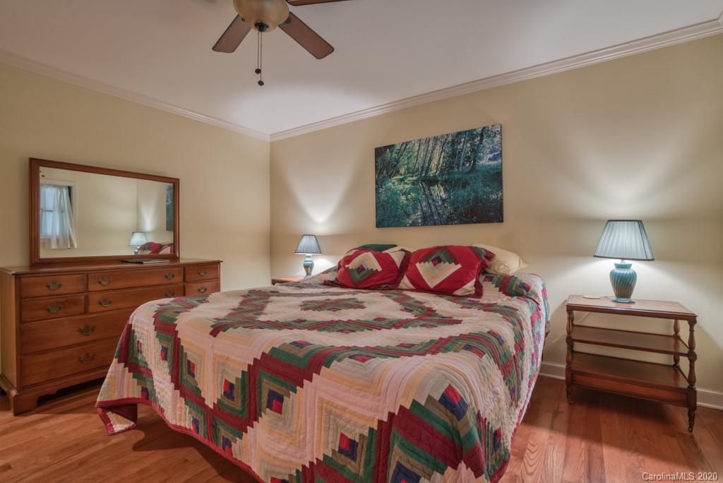 305 Misty Hill Road Columbus, NC 28722 - Photo 22 of 46 a bedroom with bed and a night stand