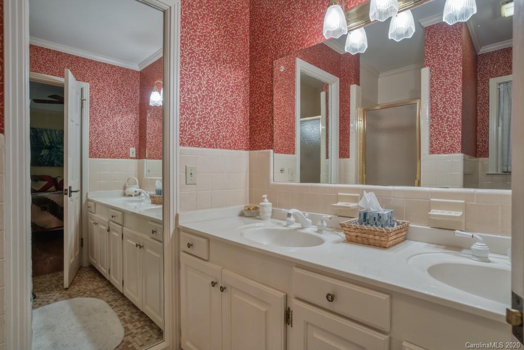 305 Misty Hill Road Columbus, NC 28722 - Photo 23 of 46 a bathroom with a sink double vanity and a mirror