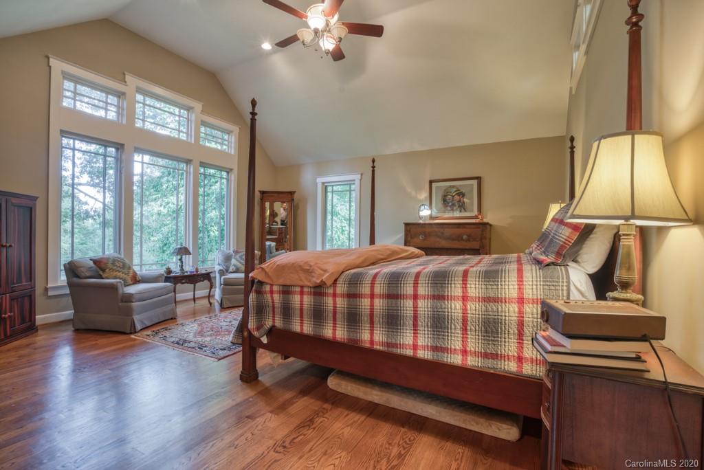 305 Misty Hill Road Columbus, NC 28722 - Photo 26 of 46 a bedroom with a bed and glass walk in closet