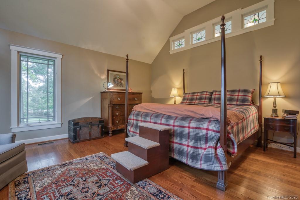 305 Misty Hill Road Columbus, NC 28722 - Photo 27 of 46 a bedroom with a bed and wooden floor