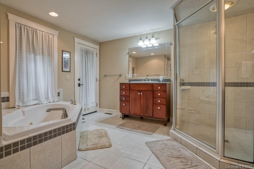 305 Misty Hill Road Columbus, NC 28722 - Photo 29 of 46 a bathroom with a tub shower and sink