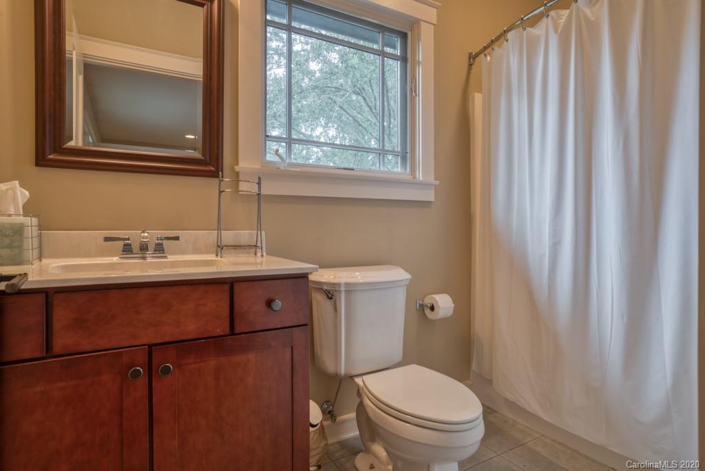 305 Misty Hill Road Columbus, NC 28722 - Photo 34 of 46 a bathroom with a toilet a sink and a mirror