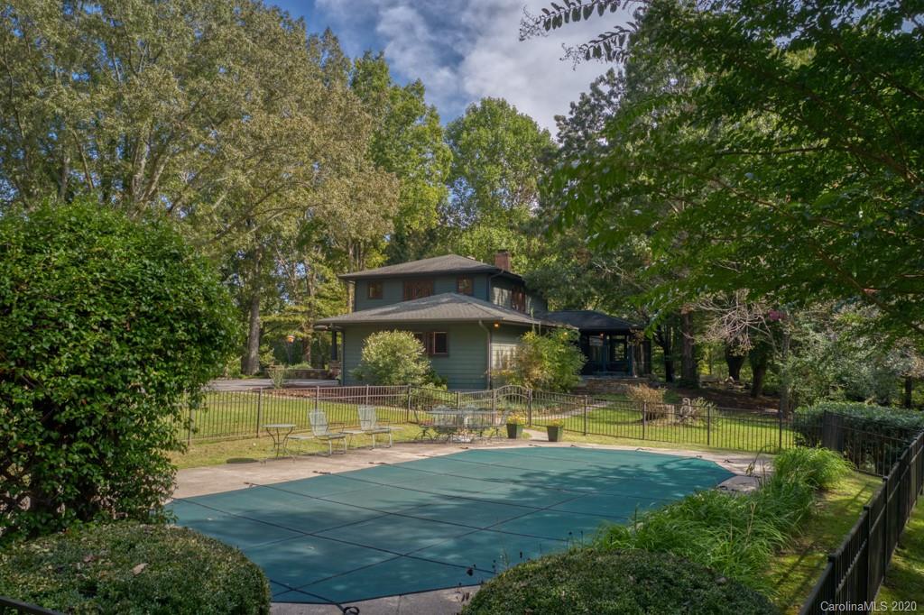 305 Misty Hill Road Columbus, NC 28722 - Photo 7 of 46 a view of a swimming pool with lawn chairs and plants