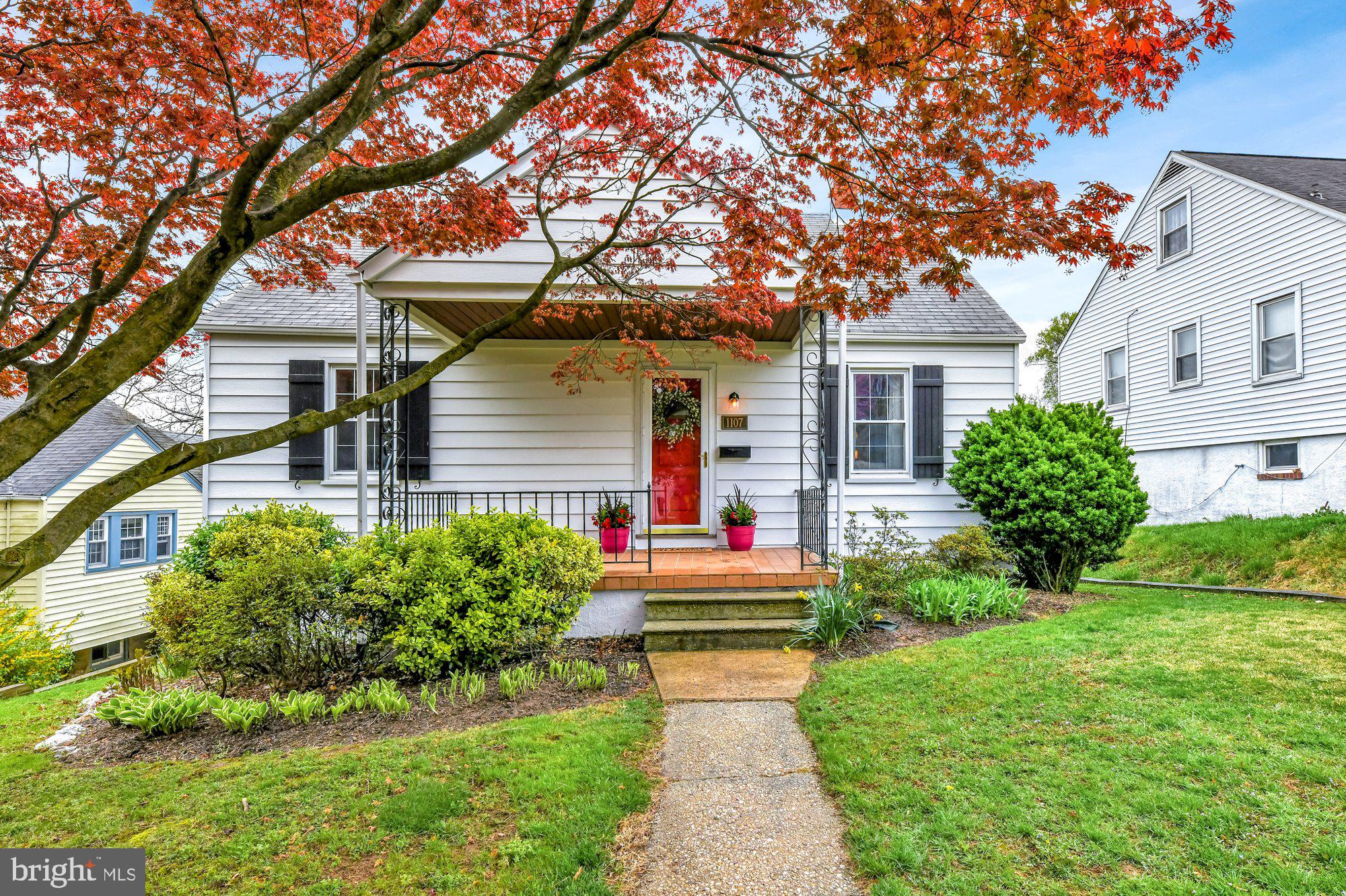 1107 Arran Road Baltimore, MD 21239 - Photo 1 of 29 a front view of a house with a small yard and potted plants