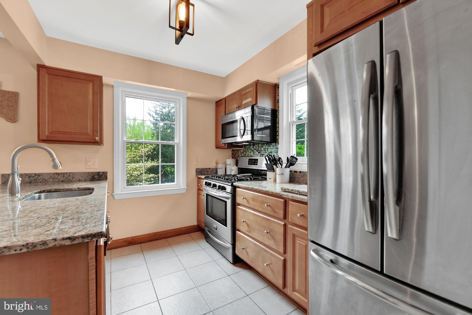 1107 Arran Road Baltimore, MD 21239 - Photo 11 of 29 a kitchen with stainless steel appliances granite countertop a refrigerator a stove a sink and a window
