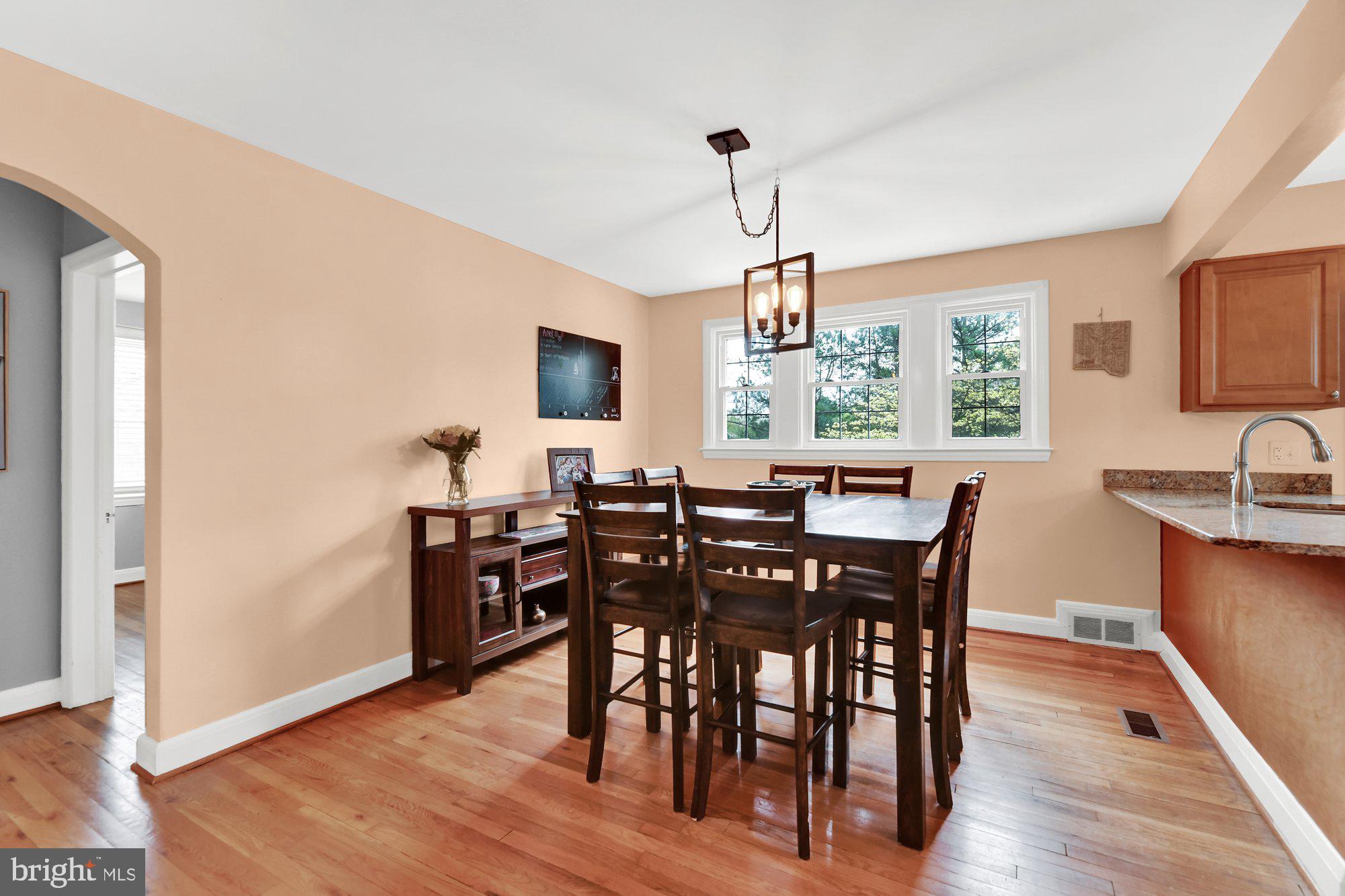 1107 Arran Road Baltimore, MD 21239 - Photo 15 of 29 a view of a dining room with furniture window and wooden floor