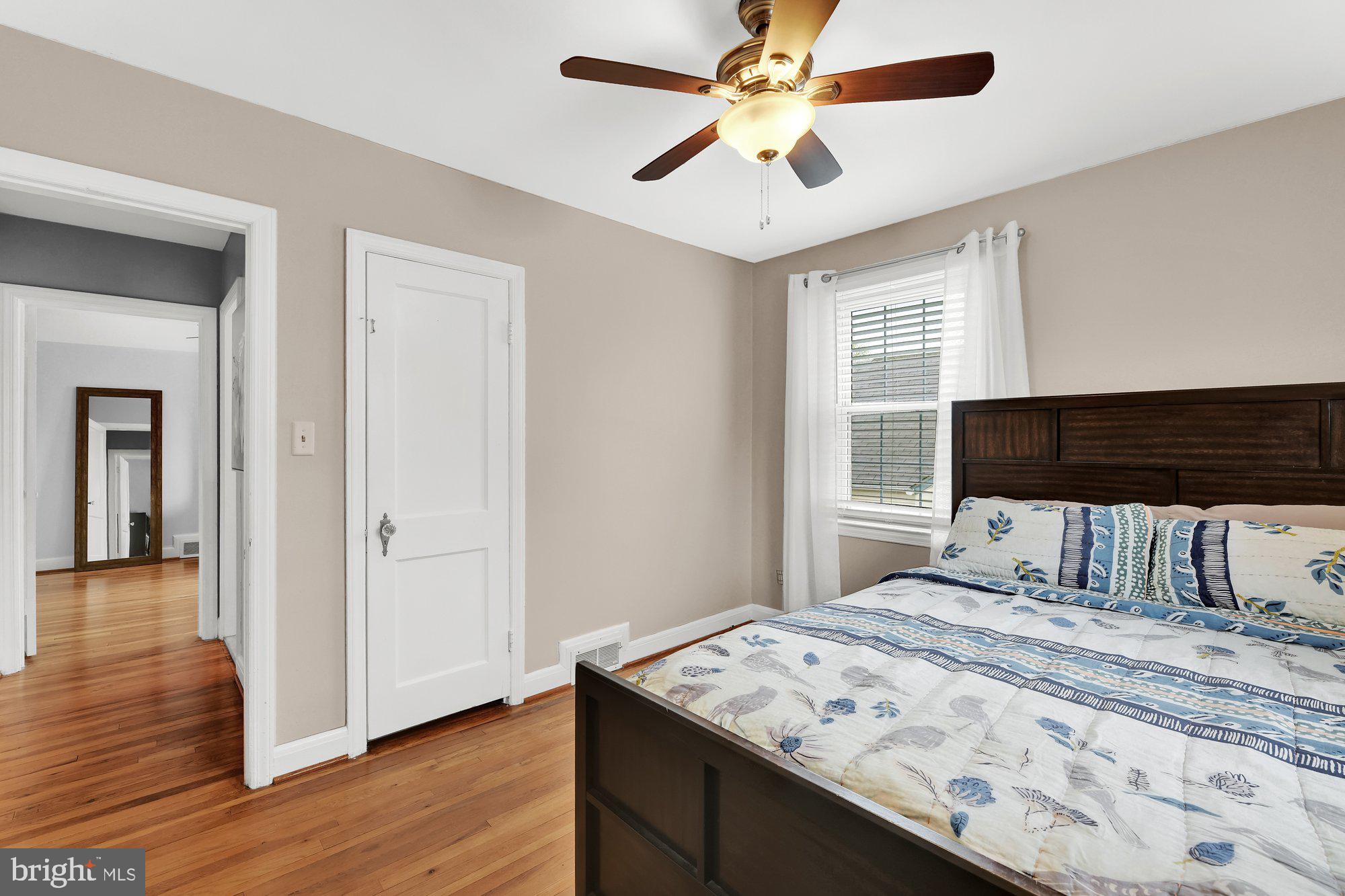 1107 Arran Road Baltimore, MD 21239 - Photo 20 of 29 a bedroom with a bed and a chandelier