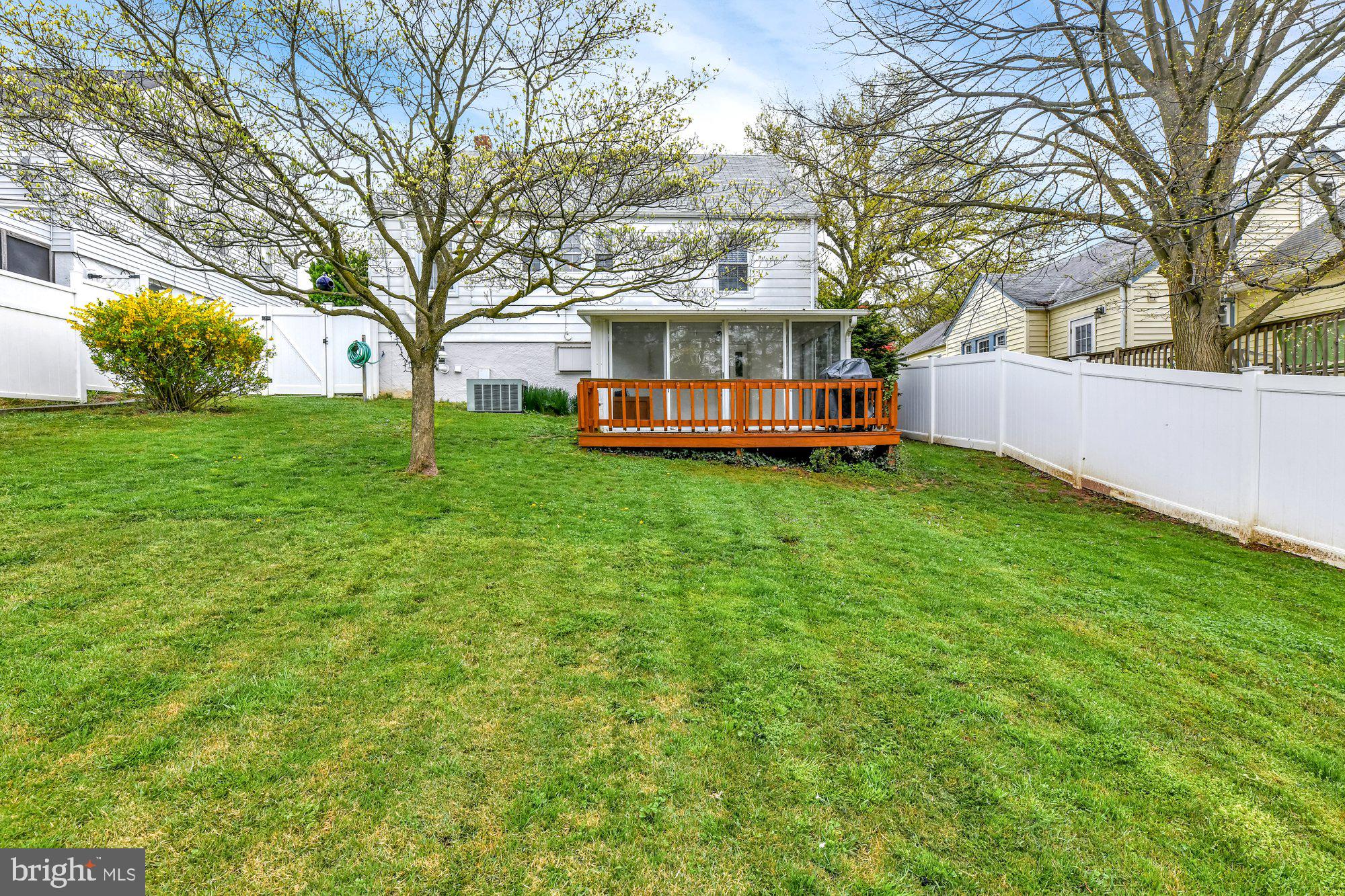 1107 Arran Road Baltimore, MD 21239 - Photo 3 of 29 a view of a house with a big yard and large trees
