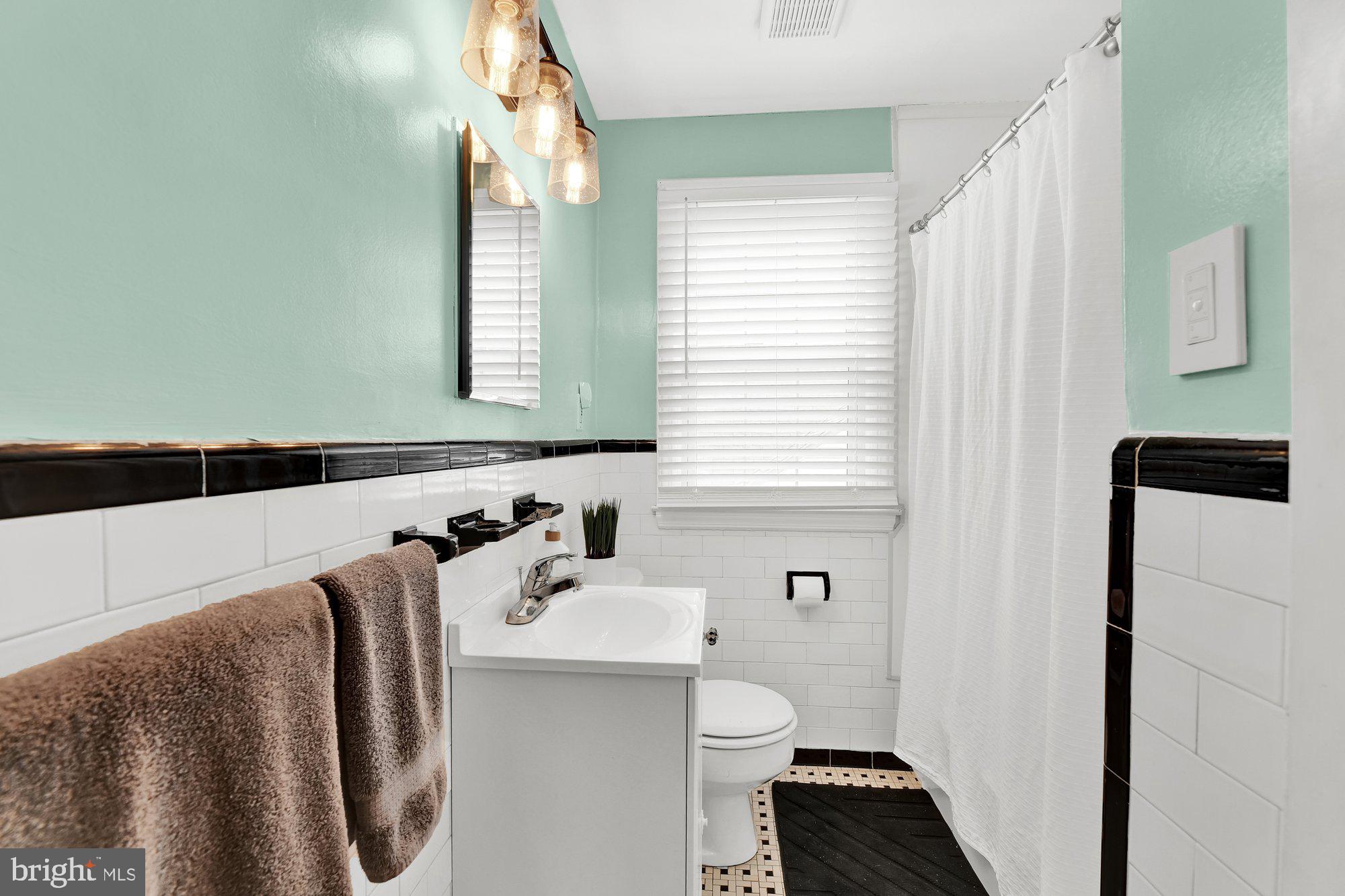 1107 Arran Road Baltimore, MD 21239 - Photo 22 of 29 a bathroom with a sink a toilet and a mirror