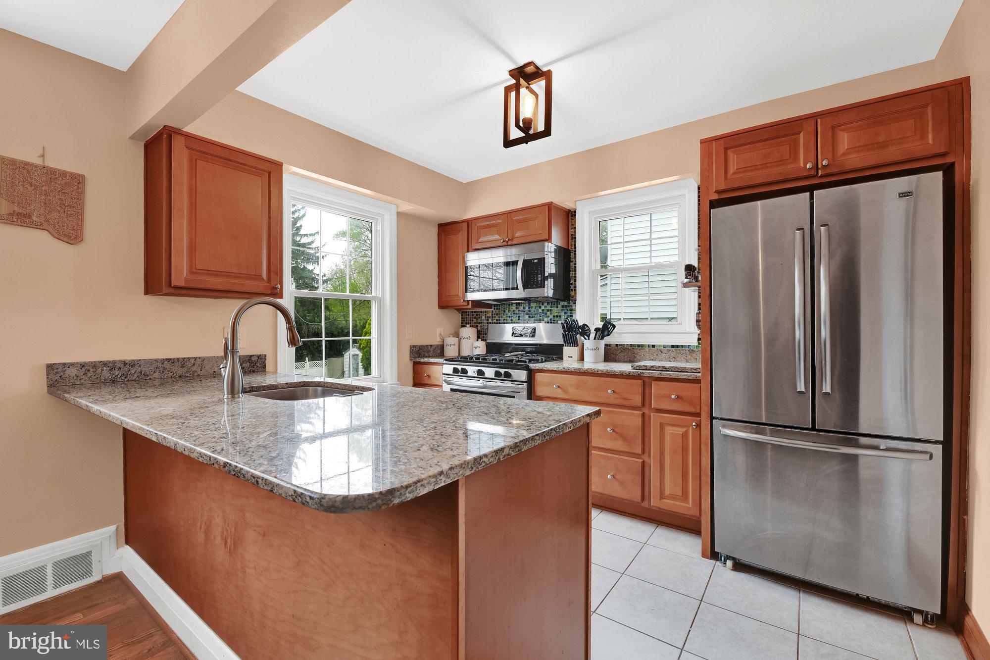 1107 Arran Road Baltimore, MD 21239 - Photo 9 of 29 a kitchen with stainless steel appliances granite countertop a refrigerator a sink dishwasher a stove a washer and dryer next to a window