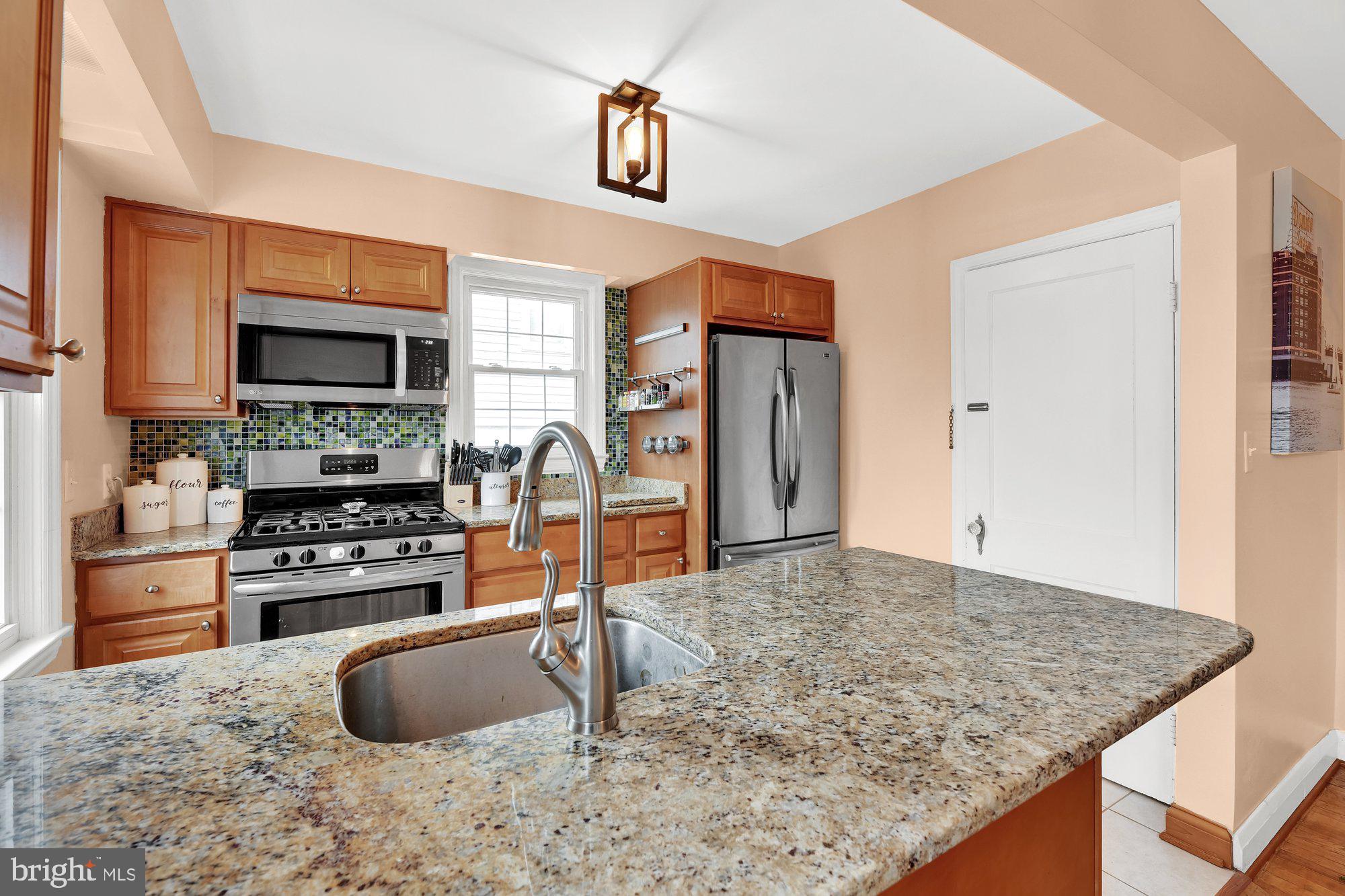 1107 Arran Road Baltimore, MD 21239 - Photo 10 of 29 a kitchen with stainless steel appliances granite countertop a stove and a sink
