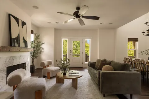 a kitchen with stainless steel appliances granite countertop a sink a stove and a wooden floor