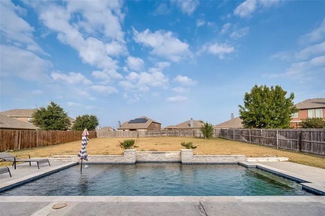 a view of outdoor space with swimming pool and seating
