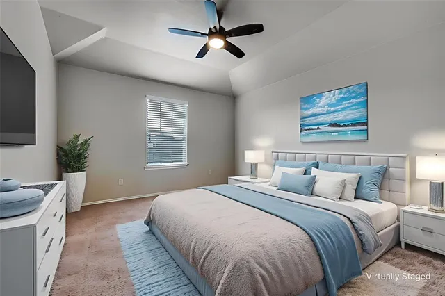 a bedroom with a large bed and a chandelier