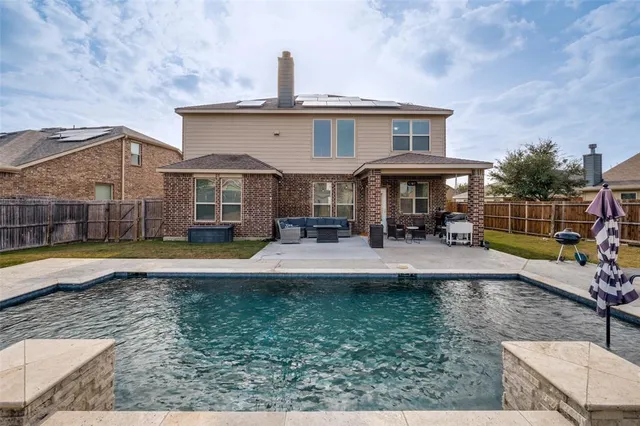 a view of a house with swimming pool and porch