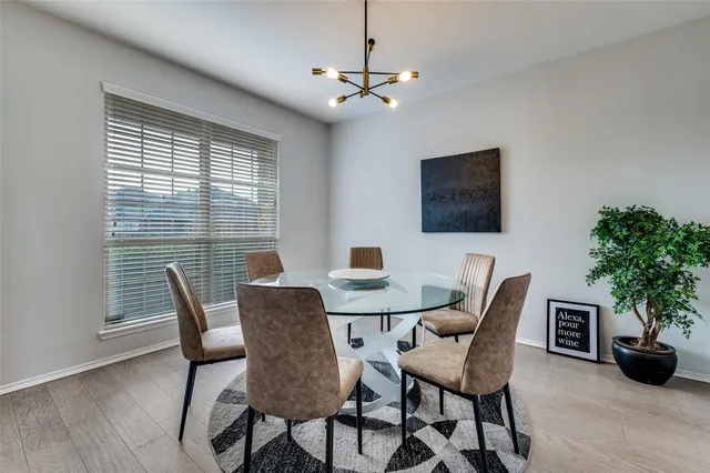 a view of a dining room with furniture and a potted plant