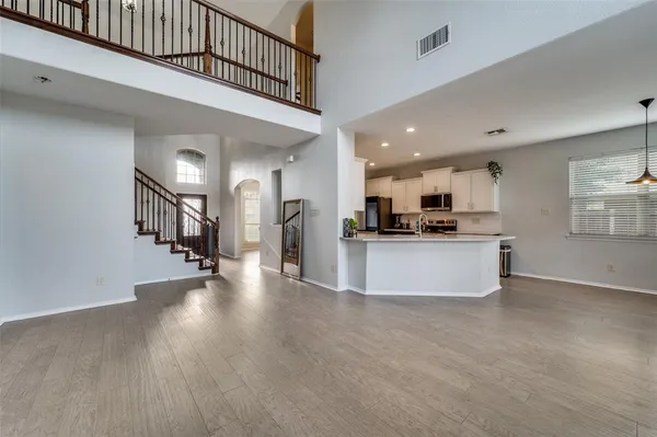 a view of kitchen with kitchen island microwave and stove