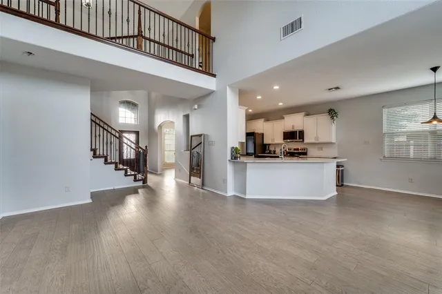 a view of kitchen with kitchen island microwave and stove