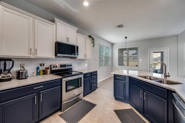 a kitchen with stainless steel appliances granite countertop a sink and stove top oven