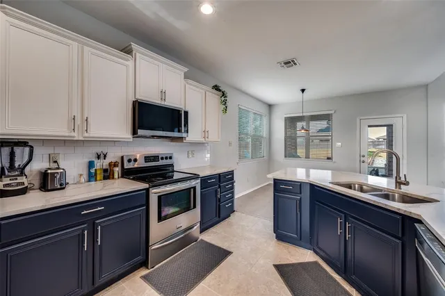 a kitchen with stainless steel appliances granite countertop a sink and stove top oven