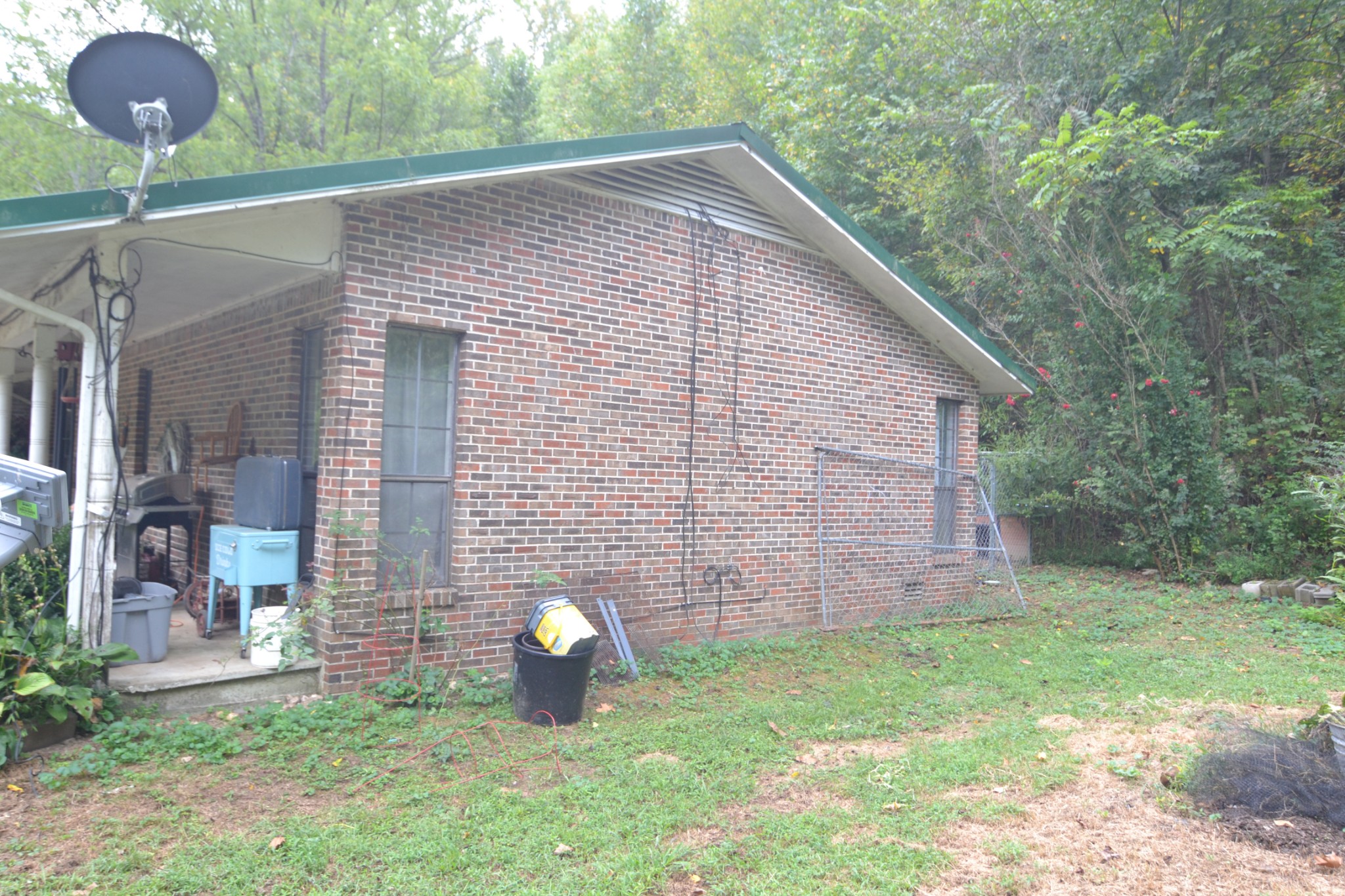555 Myrick Branch Road Pulaski, TN 38478 - Photo 28 of 40 a view of a backyard with table and chairs and wooden fence
