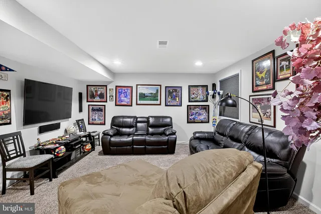 a living room with furniture and ceiling fan
